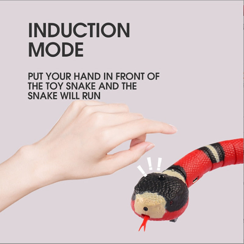 A close-up of a hand in front of a red toy snake with black and yellow stripes. The text on the image reads 'Induction Mode - Put your hand in front of the toy snake and the snake will run,' highlighting the interactive feature of the toy.