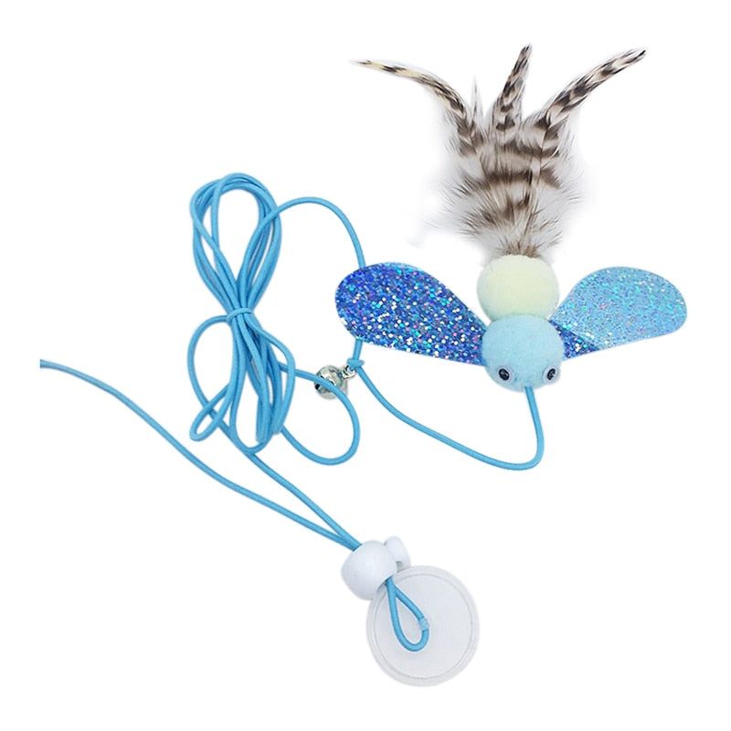 A cat toy designed to look like a bug with blue glitter wings, a light blue body, and feather accents. The toy is attached to a blue string with a suction cup for easy attachment to surfaces, offering playful entertainment for cats.